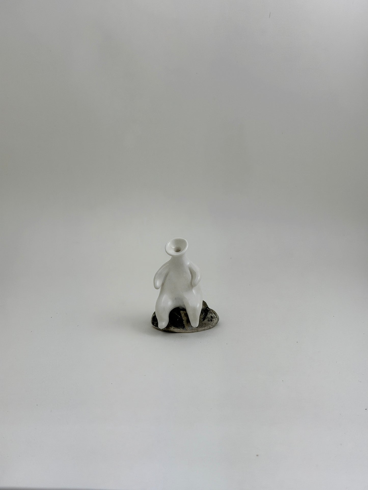 Tiny Vase Person Sitting on a Rock