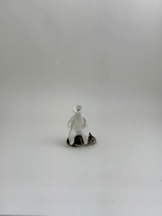 Tiny Vase Person Sitting on a Rock