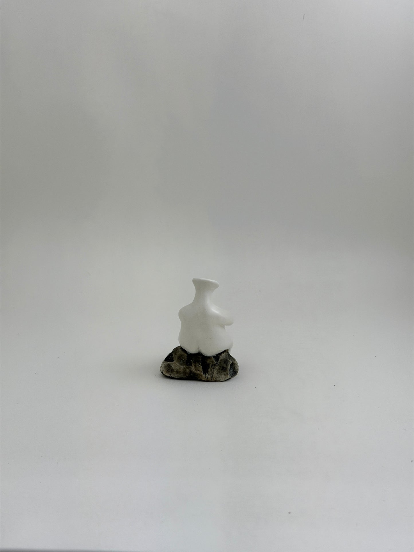 Tiny Vase Person Sitting on a Rock
